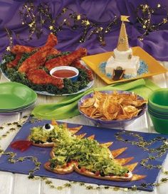 a table topped with lots of plates filled with food and condiments on top of it