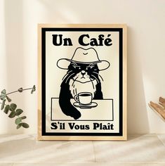 a poster with a cat wearing a hat and holding a coffee cup in front of it