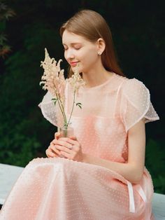 This Daisy See-through Petal Sleeve Lace Dress features a delicate and ethereal design with sheer petal sleeves that add a touch of romantic flair. The dress is adorned with a polka-dot pattern over a soft, pastel pink fabric, enhancing its dreamy aesthetic. Perfect for special occasions, this dress combines elegance with a playful charm, thanks to its lightweight lace and flowy silhouette. - Crafted from fine, see-through lace, this dress provides a subtle hint of allure while maintaining sophistication.- Petal sleeves offer a unique, floral-inspired look, making the dress ideal for spring and summer events.- The polka-dot detailing across the fabric adds a whimsical element to the overall design.- Its cinched waistline and flared skirt create a flattering silhouette that accentuates Feminine Tulle Dress With Sheer Sleeves, Sheer Feminine Dress For Spring, Feminine Sheer Dress For Spring, Spring Organza Dress With Sheer Sleeves, Feminine Organza Dresses For Spring, Elegant Spring Dress With Swiss Dot, Elegant Swiss Dot Dress For Spring, Feminine Swiss Dot Dress For Garden Party, Feminine Summer Dress With Sheer Sleeves