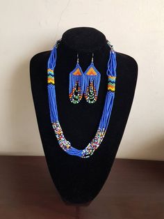 "Necklace comes with matching earrings. Dimensions: 27\" Main color: blue Available in different colors.  More necklaces here; https://www.etsy.com/shop/PrimeBeadsKe?ref=seller-platform-mcnav&section_id=33399833 All items are shipped through dhl express!" Blue Beaded Round Beads Jewelry Sets, Blue Beaded Jewelry Sets, Blue Beaded Jewelry Sets With Round Beads, Traditional Blue Beaded Earrings, Blue Jewelry Sets With Round Beads As A Gift, Blue Large Beaded Dangle Necklaces, Blue Beaded Dangle Necklace With Large Beads, Blue Large Beads Dangle Necklace, Blue Dangle Beaded Necklace With Large Beads