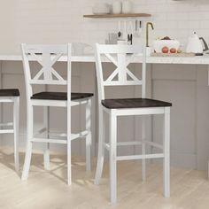 two white chairs sitting next to each other in a kitchen