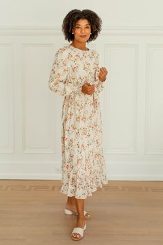 Created perfectly sweet + feminine, the 'Phyllis' floral dress is ideal for all your formal occasions this fall! The dress features a modest neckline, is fully lined, and has a dainty ruffled hemline. The pretty rust florals add the perfect autumn touch. Pair with heels, and feel beautiful and confident all day long! 100% Polyester Shell 100% Polyester Lining Fully Lined Hand Wash Cold Hang or Lay Flat to Dry Do Not Bleach Model Height 5'9" | Wearing Size Small Please carefully measure a similar Modest Neckline, Layered Tops, Feel Beautiful, Floral Ruffle, The Pretty, Blouse Dress, Tops For Leggings, How To Feel Beautiful, Ruffle Hem