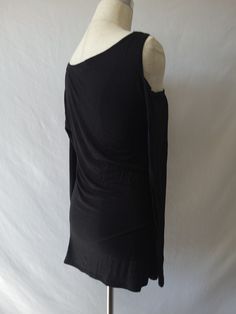 You will be " So Chic" and sexy in our shirring detail asymmetric long sleeve top. This top with hug you un all the right places and also feel comfortable with the soft,lightweight ,stretchy material. Featuring cut out right shoulder, asymmetric neckline, solid black color, long sleeves and hits you below the waist. Paired with our ''Roize'' jeans but can pair also with some distressed jeans. Rayon/Spandex Fit: True to size Made in U.S.A Machine wash cold Hang dry Summer Tops With Ruched Asymmetrical Hem, Ruched Tops With Asymmetrical Hem For Summer, Summer Ruched Tops With Asymmetrical Hem, Ruched Top With Asymmetrical Hem For Summer, Summer Ruched Top With Asymmetrical Hem, Stretch Top With Ruched Asymmetrical Neckline, Ruched Top With Stretch And Asymmetrical Neckline, Asymmetrical Neckline Top With Ruched Stretch, Asymmetrical Neckline Top With Ruched Detail