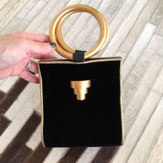 "When vintage looks this modern, it's a great thing. This black and gold evening bag/tiny tote is tres chic. So good with just about anything. Small but interestingly, roomy enough to hold a whole bunch cos of the wide roundish base. Measures 5-1/4\" (width) x 6\" (height excluding handles) x 5\" (base width) Condition: Excellent. Minor wear on gold rings. This bag is clean and ready to use. Comes from a smoke and pet free home. Don't forget to follow me on Instagram @tammaraclearshercloset for Modern Evening Bags With Brass Hardware, Gold Evening Bag With Top Carry Handle For Shopping, Vintage Gold Shoulder Bag With Top Carry Handle, Chic Gold Evening Bag With Handles, Party Gold Tote Evening Bag, Chic Gold Evening Bag With Top Handle, Chic Party Tote Evening Bag, Gold Bags With Gold-tone Hardware For Night Out, Gold Party Tote Evening Bag