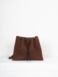 "Brown medi leather crossbody bag minimalist, Handmade leather bag, hygge leather bags, women crossbody bag, ethical bags, sustainable gifts. Cognac brown leather Origen bag Medium size. The origin collection is the simplest and purest of all my designs, the high quality of the leather and its simple lines make each bag special and unique. The medium origin leather bag is your perfect size for your everyday, traveling or going out. You can carry it over the shoulder or across the body, since the Minimalist Leather Shoulder Bucket Bag, Minimalist Leather Crossbody Bucket Bag, Minimalist Crossbody Hobo Bag, Minimalist Satchel With Leather Handles, Everyday Vegetable-tanned Crossbody Satchel, Minimalist Textured Leather Shoulder Bag, Minimalist Leather Shoulder Bag, Vegetable-tanned, Minimalist Leather Hobo Bag, Minimalist Vegetable-tanned Leather Shoulder Bag