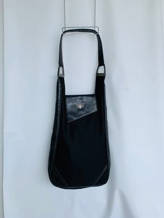 "PRADA SHOULDER BAG Black shoulder bags Genuine leather/nylon bags Gift for women Gift for her Excellent condition. Very clean, no stains inside, no any odors. Measurements: 10\" X 8\" X 16\" X 2\" Strap: 20\" Picture's colors may appear slightly different based on the monitor's setting." Designer Travel Shoulder Bag With Leather Backing, Designer Nylon Shoulder Bag For Evening, Designer Nylon Bags For Everyday Use, Designer Nylon Shoulder Bag For Daily Use, Designer Nylon Bags With Leather Handles, Designer Nylon Shoulder Bag For Business, Functional Nylon Shoulder Bag For Evening, Black Shoulder Bag Backpack With Leather Trim, Nylon Satchel Shoulder Bag With Leather Handles