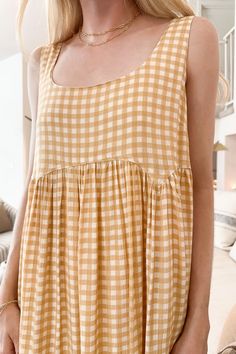 Just picture this dress billowing in the wind! The Poppy Gingham Dress is flowy and perfect for summer! Featuring a gingham pattern, yellow and off white colors, lightweight feel, babydoll silhouette, lightweight feel, lining throughout and a true to size fit. Style this gingham dress with nude heels and a neutral bag! Details & Sizing Gingham pattern Yellow and off white colors Babydoll silhouette Lightweight feel Lining throughout True to size fit fit Gabriella is wearing a size S Fabric 100% Gingham Babydoll Dress, Neutral Bag, Farm Clothes, Bag Details, Gingham Pattern, Picture This, White Colors, Gingham Dress, Nude Heels