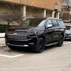 a black suv is parked in the parking lot