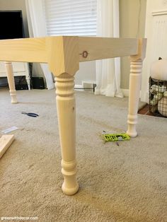 a wooden table sitting on top of a carpeted floor