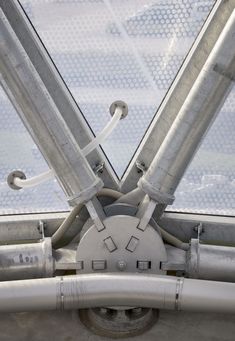 the inside view of an airplane window with metal bars and wires attached to it's sides