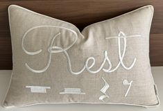 a pillow with the words rest on it