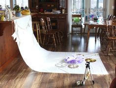 a camera set up in the middle of a living room with chairs and tables around it