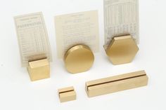 brass hardware is displayed on a white surface with some papers and instructions to make it look like hexagonal shapes