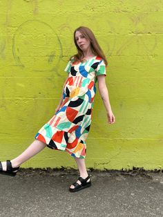 The Billie Dress is a prairie-style dress, featuring a flattering square neckline, short sleeves, loose fit, and the perfect length. Its airy fit mixed with the bold bright print makes it a comfortable everyday statement piece that can be dressed up or dressed down for any occasion. Hand sewn 100% Linen Cotton Printed with high-quality eco-friendly ink ***PLEASE READ BEFORE PURCHASE*** Please note that this garment is made to order, and production times can take up to two months. We recommend ch Casual Short Sleeve Dress With Retro Print, Casual Abstract Print Dress With Short Sleeves, Casual Short Sleeve Retro Print Dress, Casual Short Sleeve Midi Dress With Vibrant Print, Summer Dresses With Retro Print And Short Sleeves, Summer Dress With Retro Print And Short Sleeves, Casual Short Sleeve Multicolor Midi Dress, Casual Multicolor Square Neck Midi Dress, Childs Play