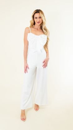 Adjustable spaghetti straps Zipper in back Some stretch Wide leg Metallic bow on chest Lined/non-sheer 95% Polyester; 5% Spandex SIZES: SMALL MEDIUM LARGE Introducing our Spaghetti Strap Big Bow Jumpsuit in a stunning off white color! Perfect for brides-to-be or anyone looking for a chic and unique outfit. Stand out with the playful and stylish big bow detail. Makes a statement without trying too hard! SIZE XS S M L XL 2XL 3XL FITS A SIZE 00-0 2-4 6-8 10-12 14-16 18-20 22-24 Elegant Spaghetti Strap Jumpsuits And Rompers For Spring, Elegant Spring Jumpsuits And Rompers With Adjustable Straps, Fitted Jumpsuits And Rompers With Spaghetti Straps For Brunch, White Fitted Jumpsuits And Rompers With Spaghetti Straps, White Fitted Jumpsuit With Spaghetti Straps, Spring Party Jumpsuits And Rompers With Bow, Spring Party Jumpsuit With Bow, Fitted Summer Jumpsuits And Rompers With Bow, Chic Summer Jumpsuits And Rompers With Bow