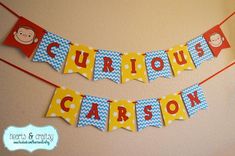 a birthday banner that says curious, curious and curious on it's string with monkeys