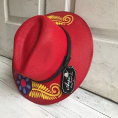 Stay stylish in this beautiful colorful hand painted straw hat, ideal for any sunny day occasion. Every single hat is hand painted uniquely which means there will never be another one like it. MADE IN MEXICO By: Mexican Artisans For: Women Size: Large (23.5") Color: red | multi Details: Material: Palm Straw Leather Band Inner elastic band Contact us for more details PLEASE READ BEFORE PURCHASE: The picture is an ACCURATE REPRESENTATION. Colors in the pictures may vary a little by effects of ligh Hand Painted Adjustable Summer Hat, Red Bohemian Straw Hat With Short Brim, Adjustable Hand Painted Summer Hat, Handmade Red Straw Hat With Curved Brim, Adjustable Curved Brim Straw Hat As Gift, Multicolor Hand Painted Straw Hat For Beach, Multicolor Hand Painted Straw Hat For Vacation, Whimsical Adjustable Straw Hat With Curved Brim, Red Summer Hat As A Gift