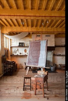 an artist's easel sitting on top of a wooden table