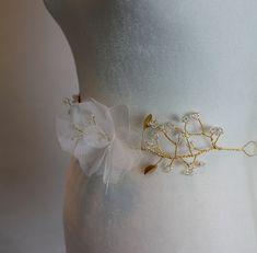 Jeweled Bridal Belt/ Wedding Sash with Silk Flowers and Beading  Make a statement in this beautifully crafted bridal belt. Made of sparkling iridescent beads and metal leaves, the branches give way to silk taffeta and soft tulle flowers. Perfect for any romantic or bohemian bride. Tied at the back with organza ribbon for a one-size-fits-all fit.  Flowers and ribbon available in: White  Light Ivory Ivory Blush Cinderella Blue Silver  Black  Leaves and wire available in: Gold Silver  Rose Gold  Pl Lily Silk, Cinderella Blue, Flower Belt, Wedding Sash Belt, Tulle Flowers, Wedding Sash, Black Leaves, Bohemian Bride, Light Ivory