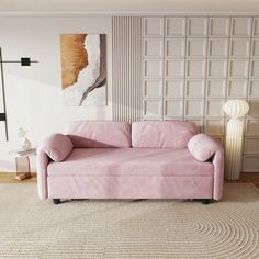 a living room with a pink couch and rug