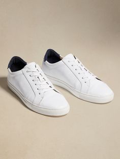 Exquisitely crafted for ultimate versatility, our Nicklas leather sneakers sport a minimal design so they pair just as easily with tailored suiting as your softest sweats.  Flexible, leather upper.  Rubber soles.  Flat laces.  Whole and half sizes. Sporty Leather Slip-on Sneakers With Contrast Sole, Modern Low-top Lace-up Shoes With Leather Sole, Casual White Lace-up Shoes With Leather Sole, Sporty Slip-on Sneakers With Perforated Toe Box For Everyday, Modern Low-top Slip-on Sneakers For Everyday, Sporty Slip-on High-top Sneakers With Leather Sole, Modern Everyday Low-top Slip-on Sneakers, Casual Custom Sneakers With Leather Sole For Sports, Casual High-top Sneakers With Leather Sole For Sports