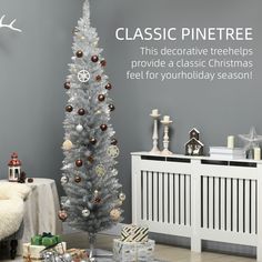 a white christmas tree sitting in front of a gray wall with presents on the floor