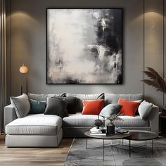 a living room filled with furniture and a large painting on the wall above it's couch