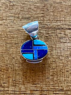 This beautifully well crafted Oval Pendant has been handmade by a Navajo Artisan. The Colors of the Pendant come from Lapis Lazuli, Turquoise and Blue Opal. The Pendant measures 1” long and 1” wide. It is stamped Sterling and signed by the Artist. “Winds of Wisdom” (Lapis Lazuli, Turquoise and Blue Opal. The Navajo (Dine’) believe that the wind is a powerful source. The native tradition believes that at any moment, the blowing wind can inspire one with hope, resolve, and great wisdom. Wisdom has Southwestern Blue Oval Jewelry, Southwestern Style Blue Oval Jewelry, Artisan Blue Inlay Necklaces, Blue Oval Southwestern Jewelry, Oval Blue Southwestern Jewelry, Traditional Blue Oval Beads Jewelry, Blue Necklace With Round Inlay, Traditional Blue Oval Beaded Jewelry, Southwestern Blue Inlay Necklace