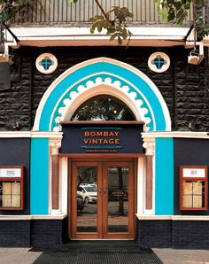 an entrance to a building with blue and white trim