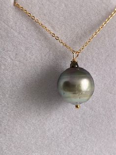 "This is a gorgeous iridescent South Sea Pearl. Beautiful  markings, Green to silver bands and a slight purple undertone to the nacre.  The nacre has a creamy feel to it.  The 14k gold filled chain is 20\".  Handmade at my summer bench in Palm Springs, CA." Handmade Tahitian Pearl Necklace Gift, High Luster Briolette Gold Jewelry, Tahitian Pearl Jewelry With High Luster, Yellow Gold Tahitian Pearl Necklace, Round Tahitian Pearl Jewelry With High Luster, Gold Round Pendant Jewelry With High Luster, Formal Gold Necklace With Tahitian Pearl, Formal Gold Tahitian Pearl Necklace, Gold Tahitian Pearl Jewelry With Pearl Charm