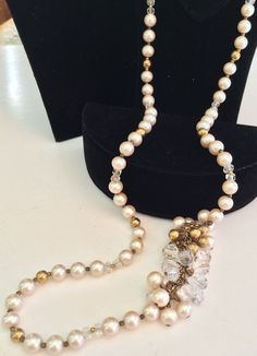 "This is an absolutely stunning vintage necklace by designer Miriam Haskell. It is beautifully crafted with a gleaming strand of creamy faux pearls with a gorgeous faux pearls and beads swag accent. The necklace pearls are strung in between tiny glinting gold tone spacer beads in a lovely pattern that includes alternating gold tone and sparkling clear faceted crystal beads. The fabulous swag is fashioned in a rich cluster of creamy lustrous faux pearls, glimmering gold tone and shimmering clear Evening Beaded Pearl Necklace In Costume Jewelry Style, Beaded Pearl Necklace For Evening In Costume Jewelry Style, Evening Beaded Costume Pearl Necklace, Beaded Costume Pearl Necklace For Evening, Vintage Pearl Necklace With Round Beads For Weddings, Vintage Single Strand Pearl Necklace For Wedding, Vintage Single Strand Necklace For Evening, Vintage Pearl Beaded Bridal Necklace, Vintage Evening Single Strand Necklace