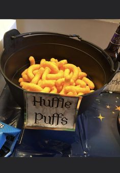 a bucket filled with fries sitting on top of a table