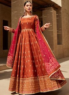 a woman in an orange and red gown