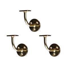 three brass - plated hooks hang on the wall