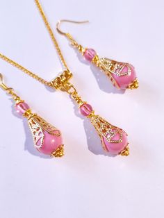 Pink pearl Gold Victorian jewelry set filigree gold set necklace and earrings Boho pink pearl jewelry set Antique style set Gift set Beautiful Set of gold tone filigree ornaments and rose pink acrylic plastic pearls beads and pink little plastic beads pendant necklace and  earrings . Antique style filigree gold tone set necklace and earrings . Gold tone plastic pearls beads Victorian style necklace and earrings . Boho necklace . Boho jewelry set . Boho earrings . Bohemian necklace and earrings . Feminine Gold Jewelry For Jewelry Making, Feminine Pink Pendant Jewelry, Elegant Pink Necklace With Intricate Design, Feminine Pink Jewelry With Pearl Drop, Feminine Pink Pearl Drop Jewelry, Elegant Pink Pendant Earrings, Formal Pink Pendant Jewelry, Elegant Pink Dangle Jewelry, Pink Jewelry With Matching Earrings Gift