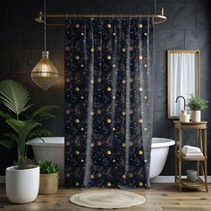 a bathroom with a shower curtain that has planets printed on it, and a bathtub in the background