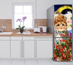 a refrigerator with an image of a doll on it's side in a kitchen