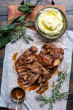 some meat and mashed potatoes on a wooden table