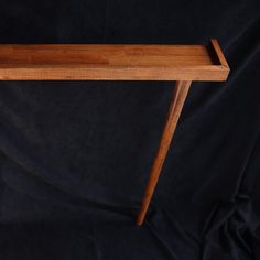 a wooden table sitting on top of a black background