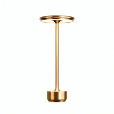 a brass plated table lamp on a white background, with the light turned off