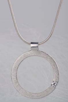 Are you looking for a gift idea for women? How about this minimalist and delicate sterling silver pendant necklace? You can choose which stone you prefer - diamond or zircon. Combination of the brilliant and delicate stone and rough, scratched silver surface makes the necklace look modern, but still subtle and elegant. Since both stones are birthstones (diamond is April birthstone and zircon is December birthstone) this necklace will be a great birthday gift for women. But it would also be a goo Modern Diamond White Pendant Necklaces, Modern Diamond White Pendant Necklace, Modern Diamond White Diamond Necklace, Modern Round Single Diamond Jewelry, Sterling Silver Jewelry With Tension Setting Round Cut, Modern Single Diamond Necklace In Diamond White, Modern Round Jewelry With Tension Setting, Modern Diamond Cut Pendant Necklace, Modern Sterling Silver Jewelry With Single Diamond