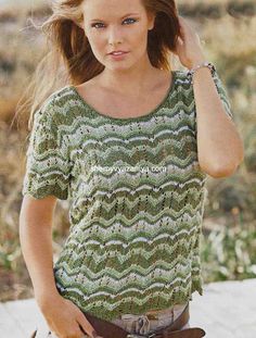 a young woman is posing for a photo while wearing a green sweater and brown belt