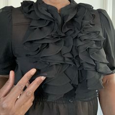 Tuxedo Style Front Ruffles. Super Cute Totally Sheer No Tags, But Never Worn, So Great Condition. Size L However, If You Have Larger Biceps, This May Be A Squeeze. Chic Fitted Ruffle Blouse, Chic Fitted Blouse With Ruffles, Chic Blouse With Ruffled Collar For Night Out, Elegant Ruffled Tops For Date Night, Elegant Black Blouse With Ruffles, Formal Black Ruffled Tops, Formal Black Tops With Ruffles, Black Fitted Blouse With Ruffled Collar, Elegant Blouse With Ruffled Collar For Night Out