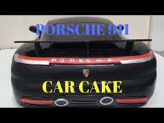 the back end of a black porsche car with yellow lettering on it's side