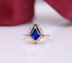 a ring with a blue stone surrounded by purple stones