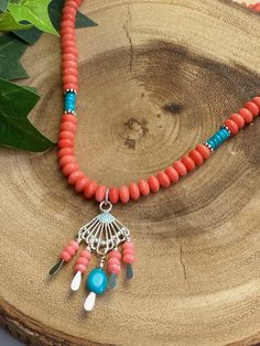 "Love the Southwest? Love Salmon pink and Turquoise together? This necklace satisfies both! Lovely, smooth Salmon pink Coral beads adorn this necklace with accents of small Sleeping Beauty Turquoise beads. These colors are so perfect together and utterly speak \"Southwest\"!. The central pendant is a fan of Sterling silver with coral beads and a stunning nugget of Sleeping Beauty Turquoise which is a rare and coveted type of Turquoise. Perfect for a collector! The necklace measures 20-inches wit Spiritual Turquoise Necklace With Lobster Clasp, Turquoise Gemstone Beads Dangle Necklace, Turquoise Dangle Necklaces With Gemstone Beads, Turquoise Heart Beads Necklaces For Jewelry Making, Spinel Jewelry, Pink Moonstone, Turquoise Pendant Necklace, Perfect Together, Southwest Jewelry