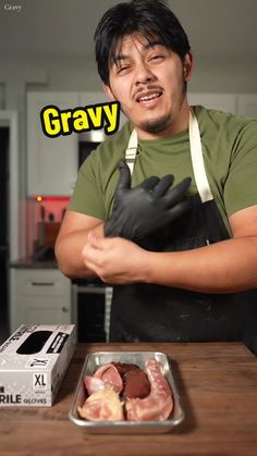 a man in an apron and black gloves is preparing food on a table with the words gravy over it