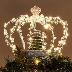 a lighted crown on top of a christmas tree