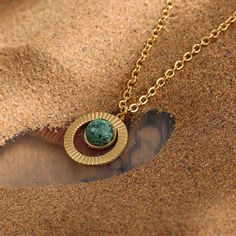 Feel the power of the sun with this exquisite Turquoise Necklace Golden Sun. Made with natural African turquoise and gold plated stainless steel, it's a piece of jewelry that is truly unique. The golden sun design is inspired by ancient Egypt and their scarab jewelry. As someone who loves to be unique, you'll definitely want to add this one-of-a-kind piece to your mystic jewelry collection.

 

 	Size: 18 inches
 	Free Shipping 2 Days
 	Authentic Green Stone: African Turquoise
 	Gold Plated