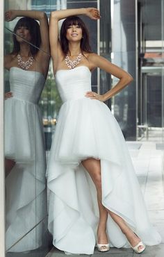 two women in white dresses standing next to each other